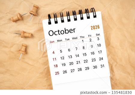 October 2026 white desk calendar with wooden thumbtack on old crumpled paper. October 2026 white desk calendar with wooden thumbtack on old crumpled paper. 135481830