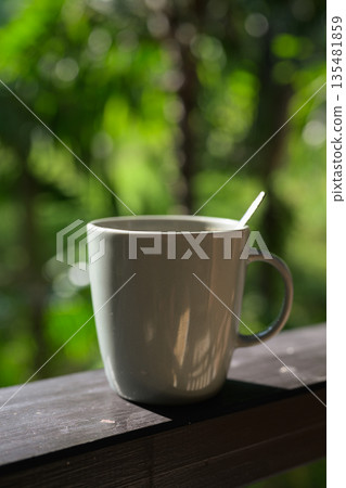Coffee Cup with Tropical Leaves Background for Morning Lifestyle Concept Coffee Cup with Tropical Leaves Background for Morning Lifestyle Concept 135481859