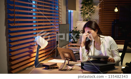 Serious Architect interior designer working overtime Serious Architect interior designer working overtime 135482343