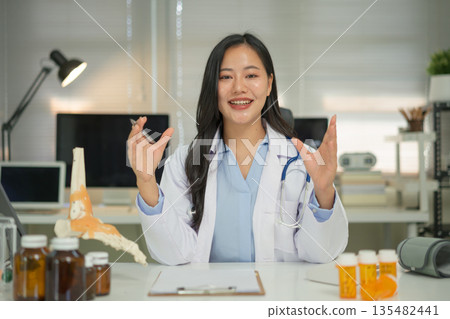 Doctor telemedicine consultation talking with video call to patient 135482441