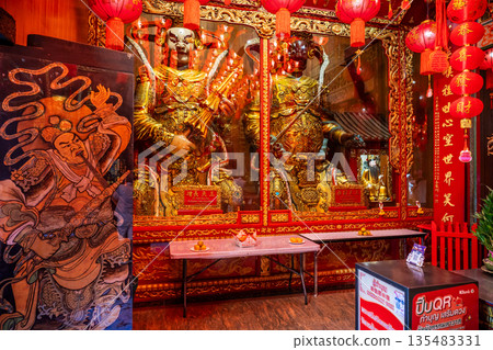 Golden Chinese-style Bodhisattva statues and ornate red interior decorations at Wat Mangkon Kamalawat during a spiritual ceremony 135483331