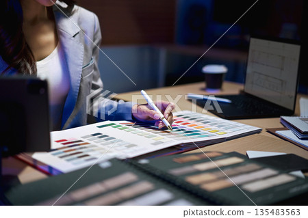 interior designer working on new house project in office. choosing materials and colors from samples 135483563