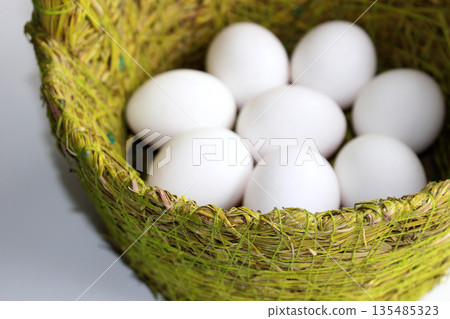 White Eggs In A Handmade Wicker Basket Detailed Stock Photo White Eggs In A Handmade Wicker Basket Detailed Stock Photo 135485323