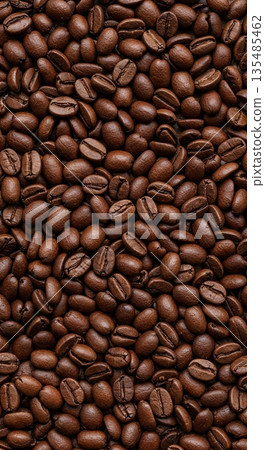 Roasted brown coffee beans create a captivating full-frame background pattern, highlighting their rich texture and deep, dark color under even lighting. Roasted brown coffee beans create a captivating full-frame background pattern, highlighting their rich texture and deep, dark color under even lighting. 135485462