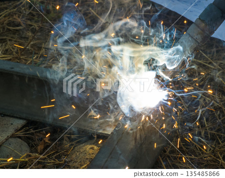 Welding equipment at construction site with sparks and smoke 135485866