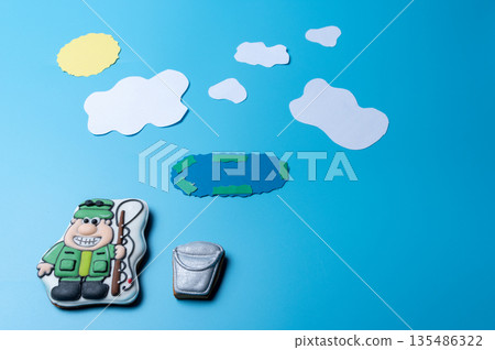 Fisherman with a bucket and fishing rod on the background of the lake. 135486322