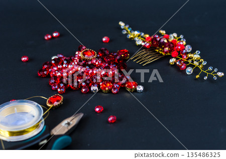 Tools, wire and jewelry made of stones. Front view. 135486325