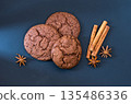 Chocolate biscuits with spices and cinnamon. Ray of light in the composition. 135486336