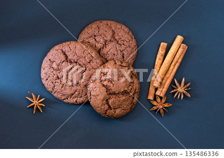 Chocolate biscuits with spices and cinnamon. Ray of light in the composition. Chocolate biscuits with spices and cinnamon. Ray of light in the composition. 135486336