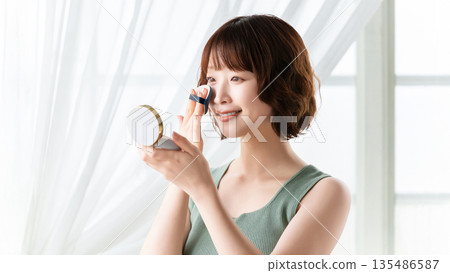 Woman applying makeup/beauty image 135486587