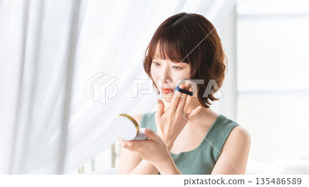 Woman applying makeup/beauty image 135486589