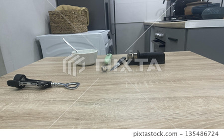 a corkscrew on the left side of the table a corkscrew on the left side of the table 135486724