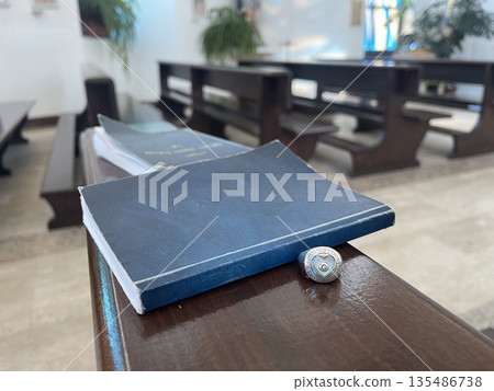 new statement and Catholic ring on the bench in church 135486738