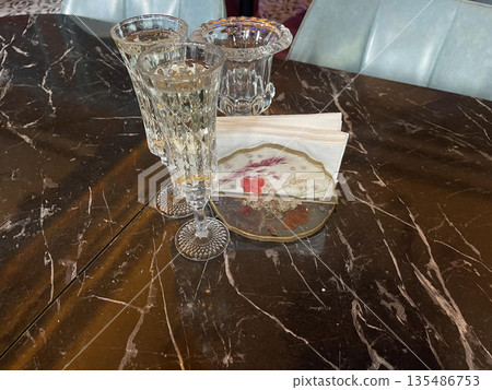 transparent glasses on the table in restaurant 135486753