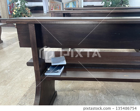 new testaments on the bench with ring in catholic church 135486754