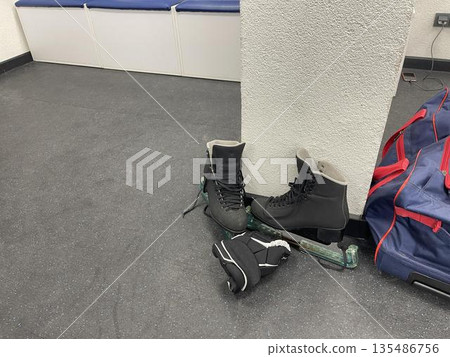 sportswear and skates for a hockey player in the team's locker room sportswear and skates for a hockey player in the team's locker room 135486756