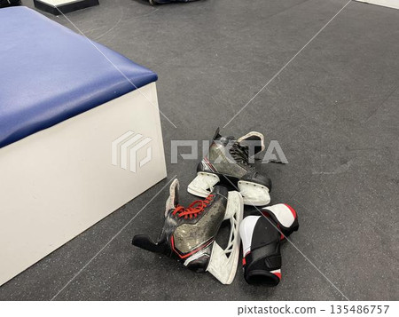 sportswear and skates for a hockey player in the team's locker room 135486757