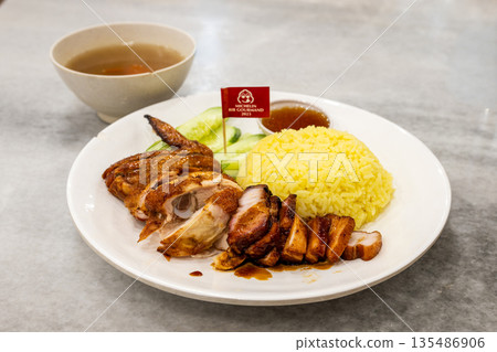 Malaysian specialty chicken rice and roast pork on a plate from a Michelin-starred restaurant Malaysian specialty chicken rice and roast pork on a plate from a Michelin-starred restaurant 135486906