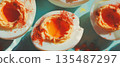 Creamy deviled eggs garnished with paprika, perfect for parties and gatherings. 135487297
