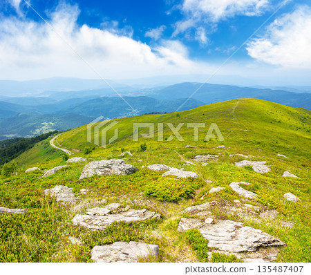 mountain landscape in summer with rocks. green grass under blue sky. alpine meadow and rolling hills with boulders on sunny day. environment sustainability and protection. background for earth day 135487407