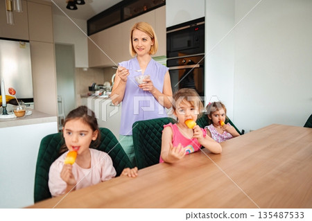 Joyful moments with family enjoying ice cream together Joyful moments with family enjoying ice cream together 135487533
