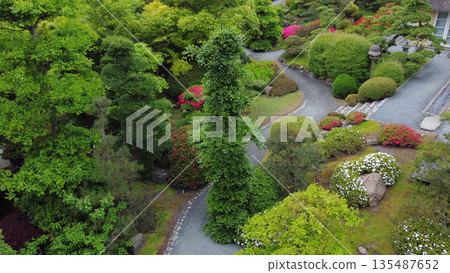 Aerial view on topiary: pruned plants and houses in Japanese style in distance in Odense Japanese  garden 135487652