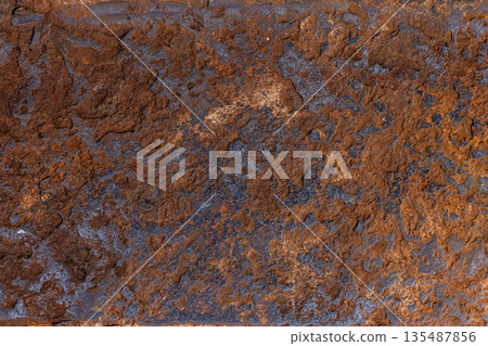 Rough textured rust surface in natural outdoor setting 135487856