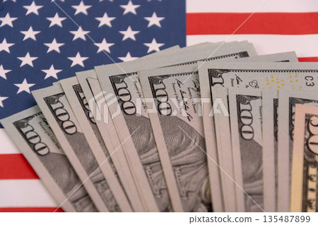 Close up of US dollar bills on the American flag Close up of US dollar bills on the American flag 135487899
