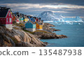 Colorful Arctic Village on Rocky Shore with Icebergs 135487938
