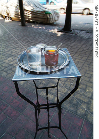 Street cafe for tea and smallest table Tea ; glass of water and sugar Street cafe for tea and smallest table Tea ; glass of water and sugar 135487990