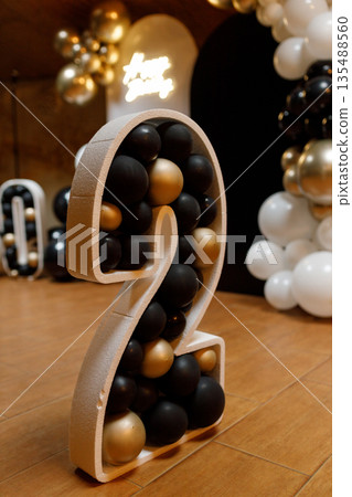 Number 2 birthday decoration with black gold and white balloons 135488560