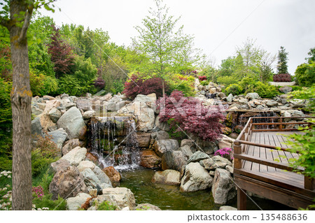Waterfall and wooden path in Japanese garden 135488636
