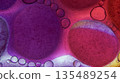 Oil bubbles floating in colored water - Macro. 135489254