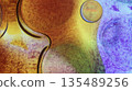 Oil bubbles floating in colored water - Macro. 135489256