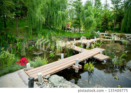 Wooden zigzag bridge in Japanese garden in Krasnodar 135489775