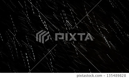 Falling Snow Night Background. Heavy snowfall at night on black background. Abstract winter texture and atmospheric effect. 135489828