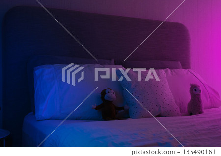 Empty bedroom with plush toys and neon lighting 135490161