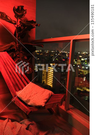 Balcony with city night view and red lighting 135490181