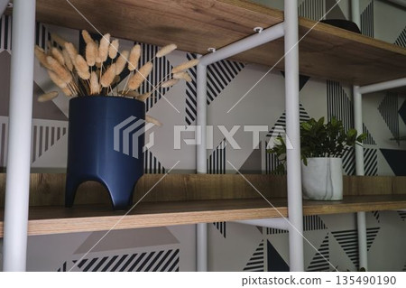 Modern open shelving with dried grass and plants 135490190