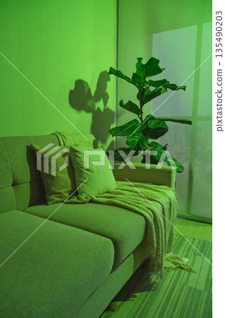 Modern living room with green ambient lighting creating mood 135490203