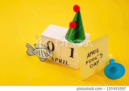 April fool's day celebrating with paper fish and party hat 135491097