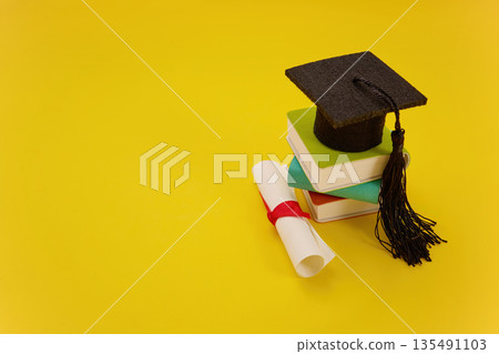 Mortarboard, diploma, and books signifying academic achievement 135491103