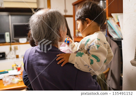 Boy playing with grandfather 135491152