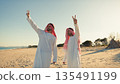 Two Sheiks Making The Victory Gesture In The Desert 135491199