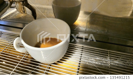 Freshly Brewed Espresso in a White Cup on a Coffee Machine Freshly Brewed Espresso in a White Cup on a Coffee Machine 135491215