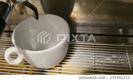 White Ceramic Coffee Cup Under Espresso Machine Spout 135491221