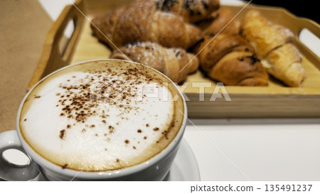 Delicious Coffee and Fresh Croissants on a Wooden Tray 135491237