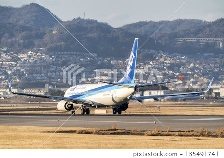 Osaka Airport (Itami Airport) in the evening. A plane taking off. Toyonaka City, Osaka Prefecture. 135491741
