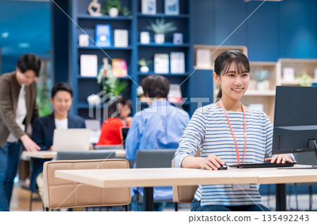 Young female engineer working in an office Young female engineer working in an office 135492243
