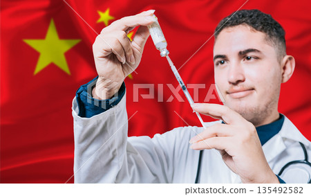 Doctor holding syringe on China flag background. Medical professional holding syringe with Chinese flag in the background Doctor holding syringe on China flag background. Medical professional holding syringe with Chinese flag in the background 135492582